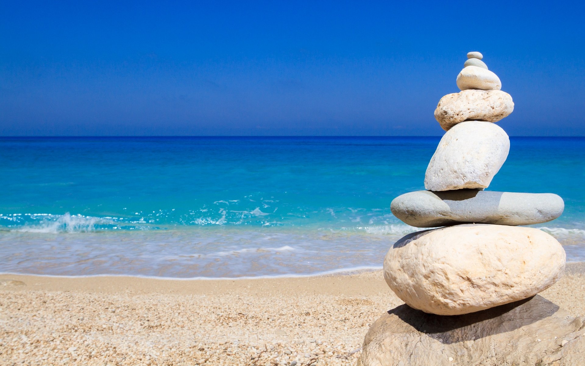 Pebbles Stack Balance Over Blue Ionian Sea